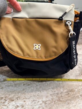 Sherpani Casual Crossbody Bag with Mustard Flap and Black Body